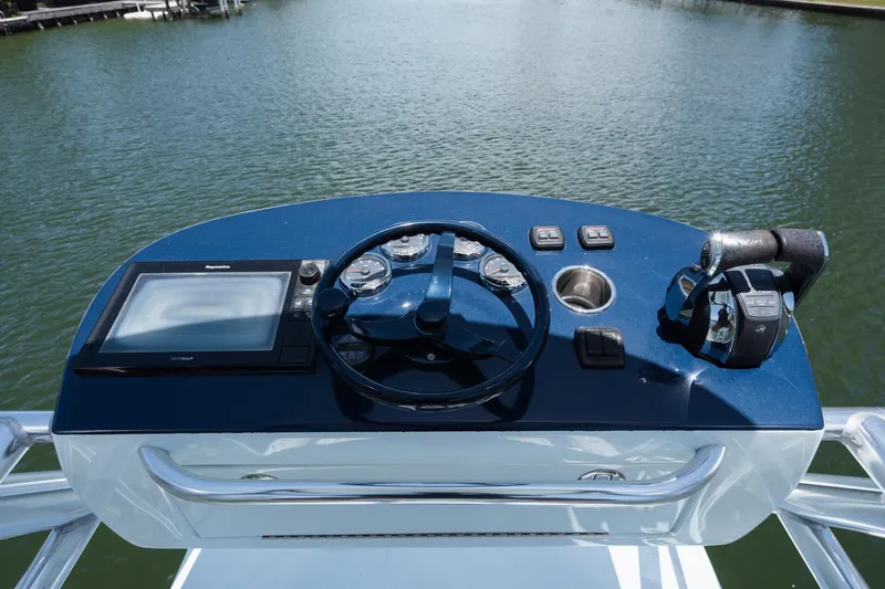  Yacht Photos Pics 2017 SeaVee 390Z helm with navigation controls and steering wheel on calm water.