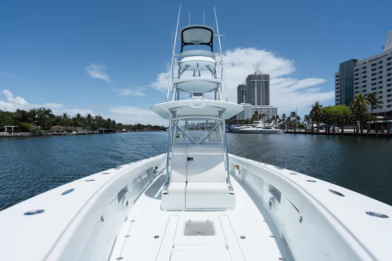  Yacht Photos Pics 2017 SeaVee 390Z boat on a scenic waterway with city skyline backdrop.