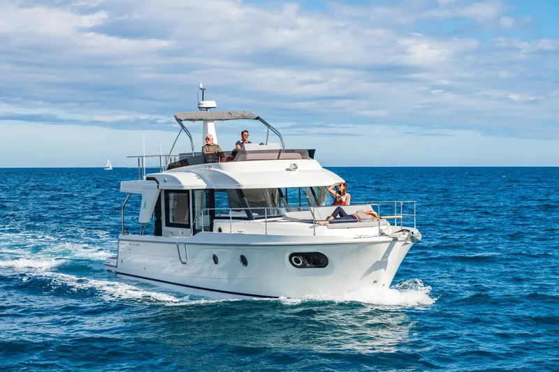  Yacht Photos Pics 2026 Beneteau Swift Trawler 41 cruising on open sea under clear skies.