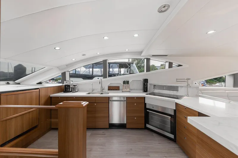  Yacht Photos Pics Luxurious yacht kitchen interior with modern appliances, wooden cabinetry, and sleek countertops, Primorets Custom 2010.