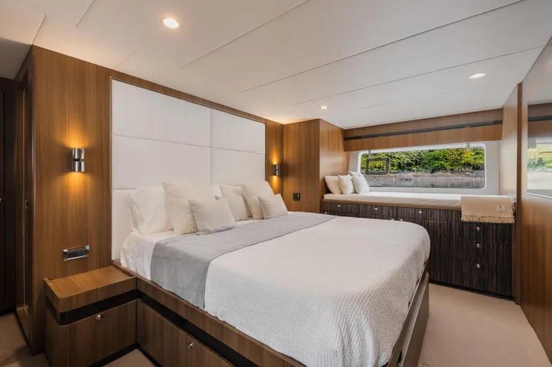  Yacht Photos Pics Luxurious bedroom interior on a 2010 Primorets Custom yacht, featuring elegant wood paneling.