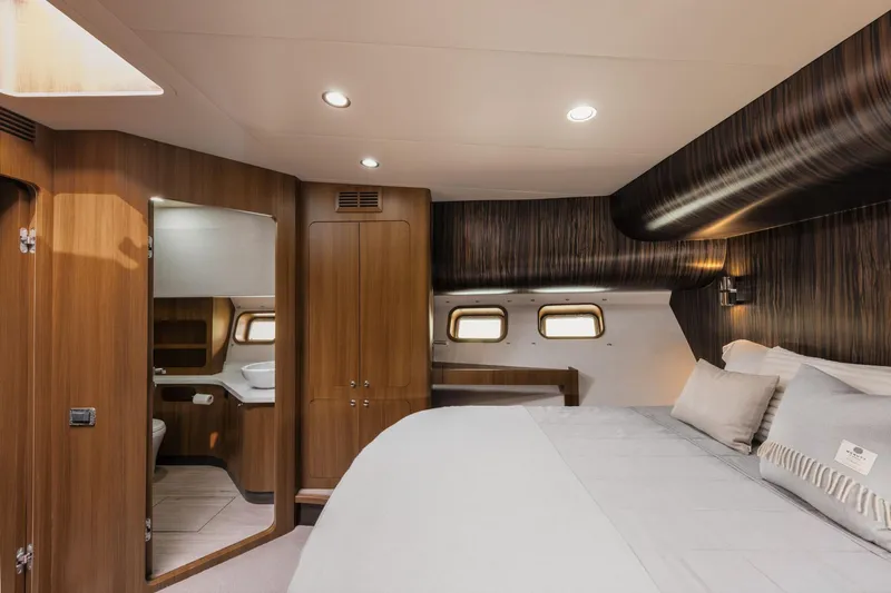  Yacht Photos Pics Luxurious yacht bedroom with wood paneling, modern lighting, and cozy bedding, Primorets Custom 2010.
