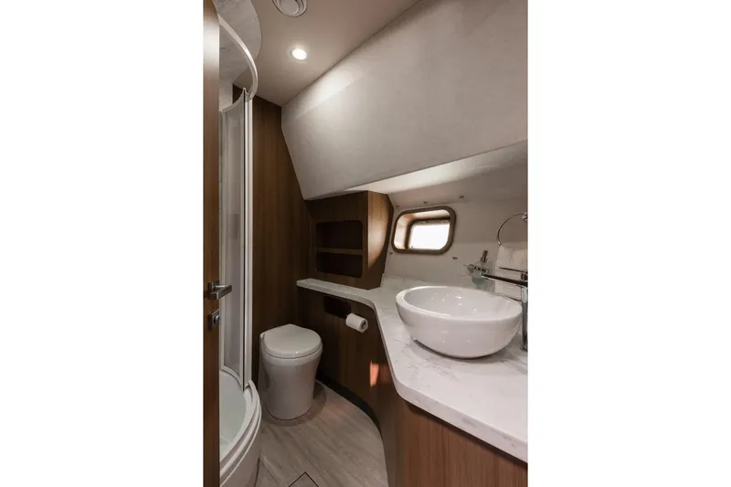  Yacht Photos Pics Modern yacht bathroom with round sink, wooden accents, and porthole window, Primorets Custom 2010.