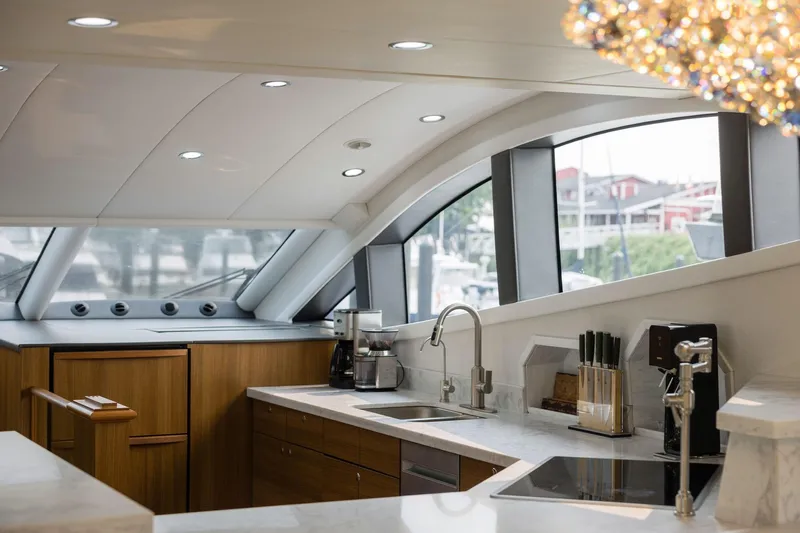  Yacht Photos Pics Luxurious yacht kitchen interior with modern appliances, sleek countertops, and elegant lighting. Primorets Custom 2010.