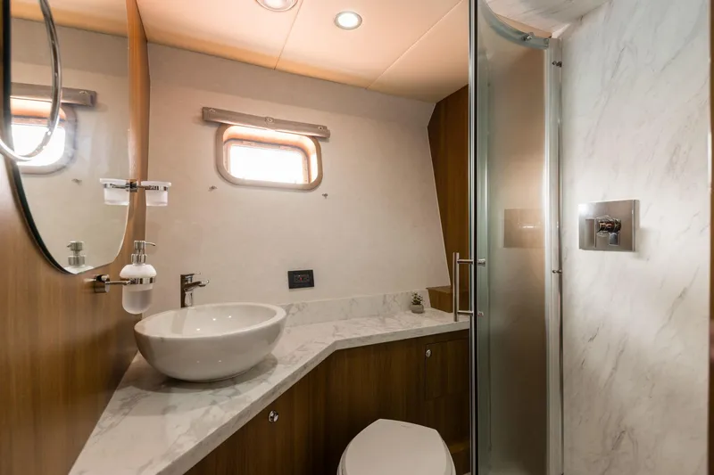  Yacht Photos Pics Luxurious yacht bathroom with modern fixtures, marble countertop, and glass shower, Primorets Custom 2010.