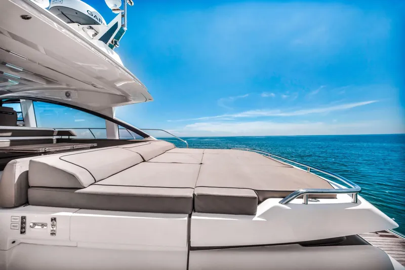 Karisa Yacht Photos Pics 2018 Fairline Targa 53 OPEN yacht with sunbed, ocean view, and clear blue sky.