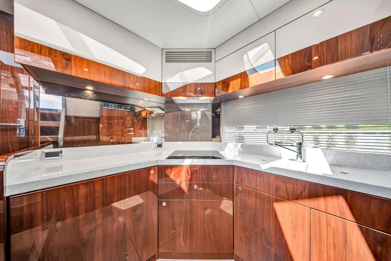 Karisa Yacht Photos Pics Luxurious kitchen interior of 2018 Fairline Targa 53 OPEN yacht with modern wood cabinetry.