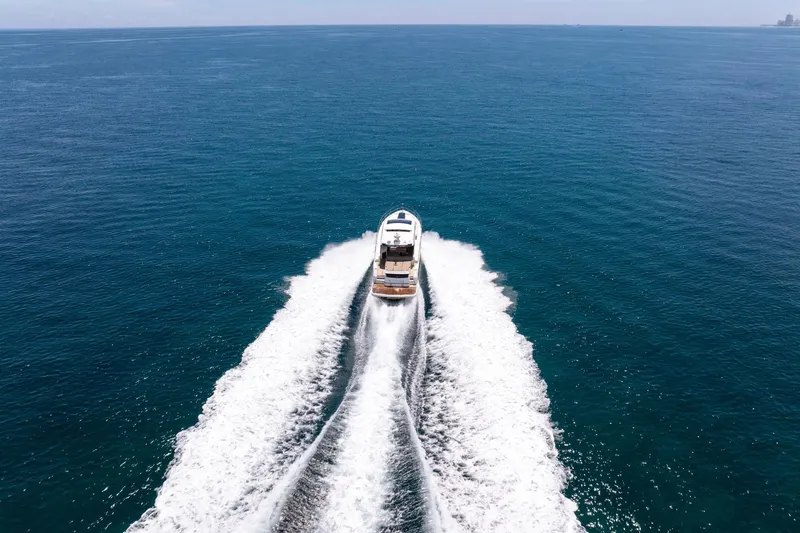 Karisa Yacht Photos Pics 2018 Fairline Targa 53 OPEN yacht cruising on open sea, leaving a wake.