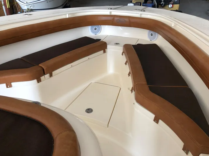  Yacht Photos Pics 2016 Scout 350 LXF boat interior with brown cushioned seating and speakers.