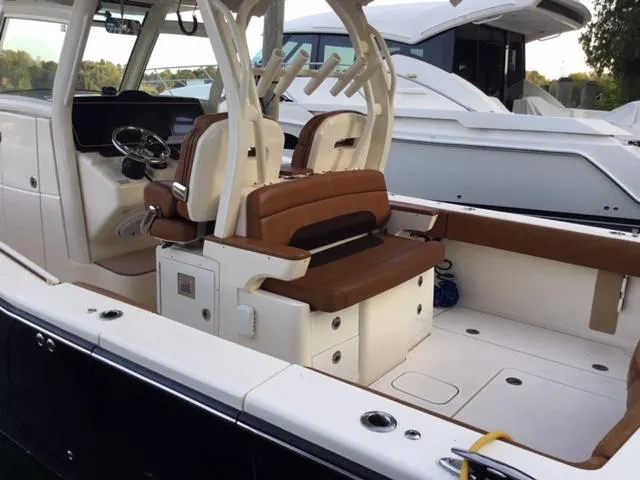  Yacht Photos Pics 2016 Scout 350 LXF boat interior with brown seating and modern helm.