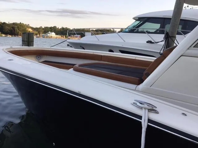 Yacht Photos Pics 2016 Scout 350 LXF boat docked, featuring sleek design and comfortable seating.