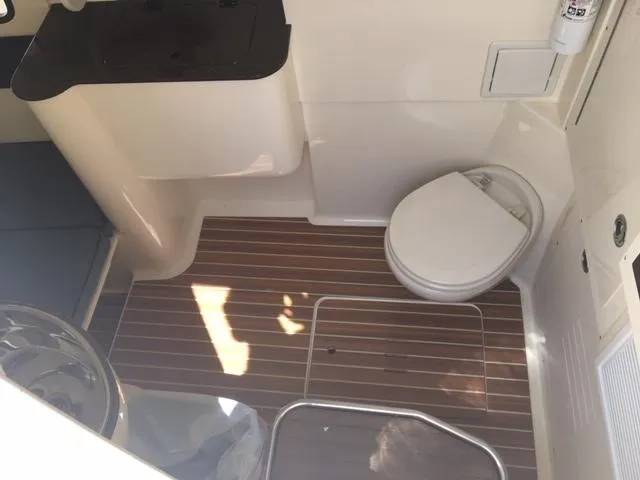 Yacht Photos Pics 2016 Scout 350 LXF boat interior with toilet and wooden flooring.