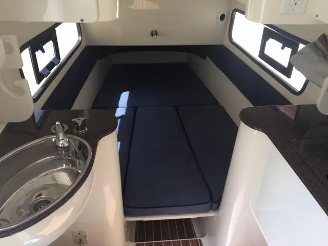  Yacht Photos Pics 2016 Scout 350 LXF cabin interior with bed, sink, and windows.