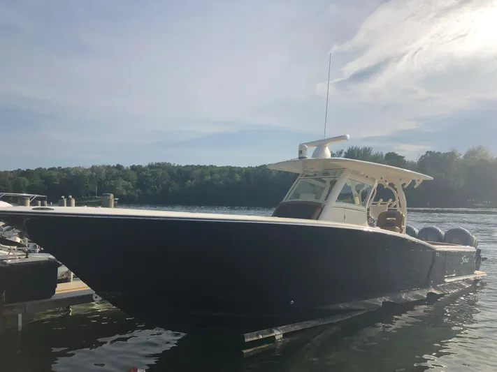  Yacht Photos Pics 2016 Scout 350 LXF boat docked on a sunny day with trees in the background.