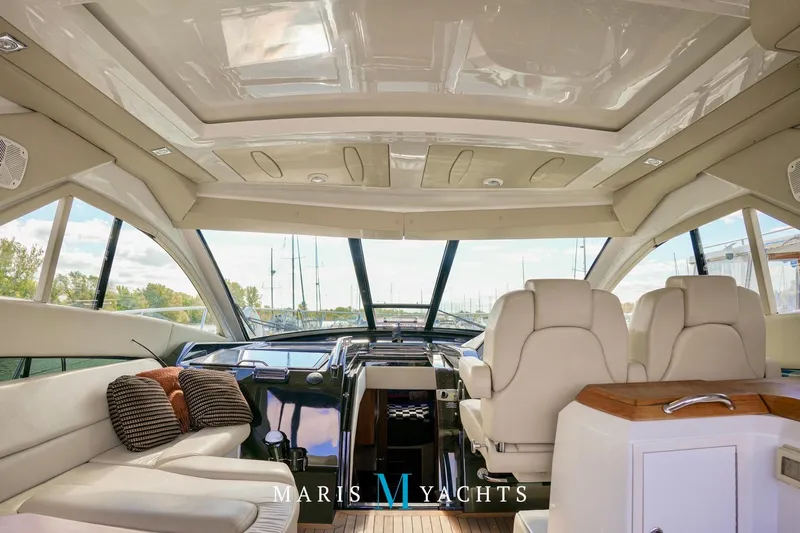  Yacht Photos Pics Luxurious interior of 2009 Regal 52 Sport Coupe yacht with plush seating and panoramic windows.