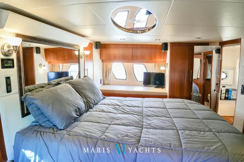 Yacht Photos Pics Luxurious interior of 2009 Regal 52 Sport Coupe yacht bedroom with modern amenities.
