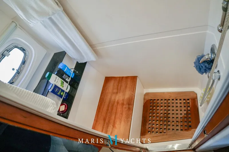  Yacht Photos Pics Luxurious 2009 Regal 52 Sport Coupe yacht bathroom with wooden accents and toiletries.