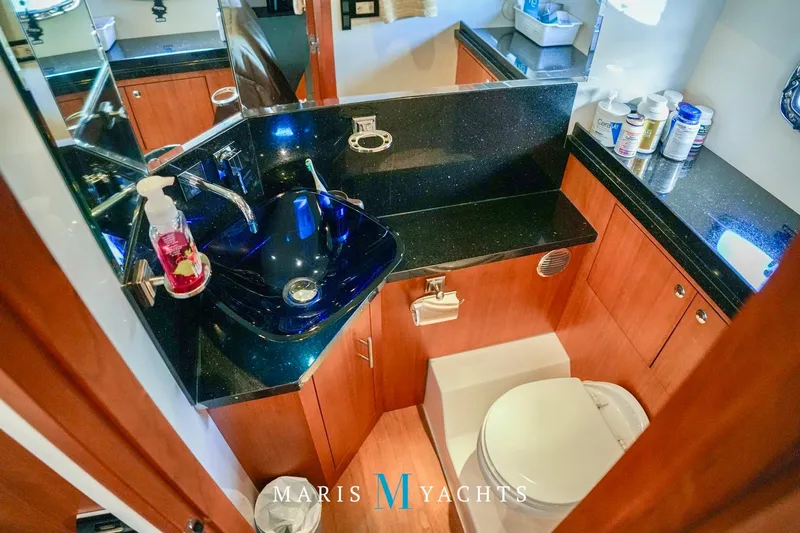  Yacht Photos Pics Luxurious bathroom in 2009 Regal 52 Sport Coupe yacht with modern fixtures and wood cabinetry.