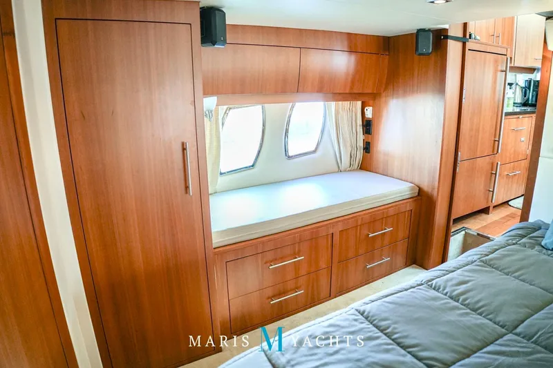  Yacht Photos Pics Luxurious interior of 2009 Regal 52 Sport Coupe yacht with wooden cabinetry and cozy seating.
