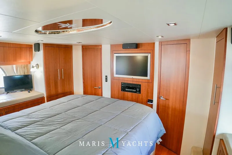  Yacht Photos Pics Luxurious bedroom interior of 2009 Regal 52 Sport Coupe yacht with modern amenities.