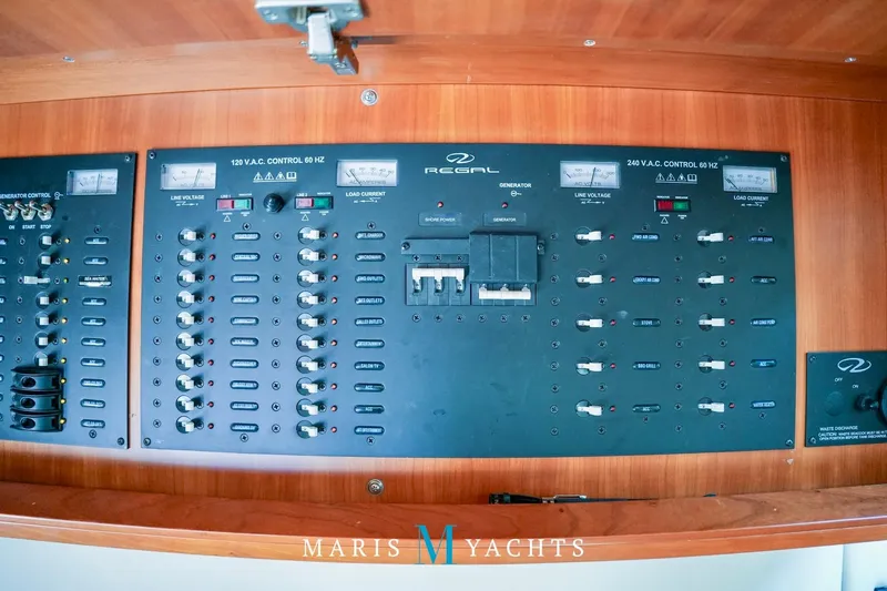  Yacht Photos Pics Control panel of a 2009 Regal 52 Sport Coupe yacht with various switches and gauges.