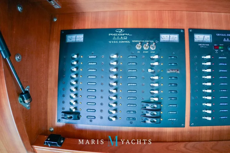  Yacht Photos Pics Electrical control panel on 2009 Regal 52 Sport Coupe yacht, featuring switches and gauges.