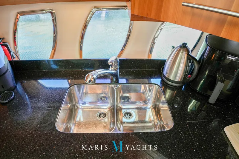  Yacht Photos Pics Kitchen area of 2009 Regal 52 Sport Coupe yacht with sink and appliances.