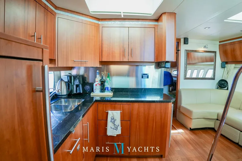  Yacht Photos Pics Luxurious 2009 Regal 52 Sport Coupe yacht interior with modern kitchen and seating area.