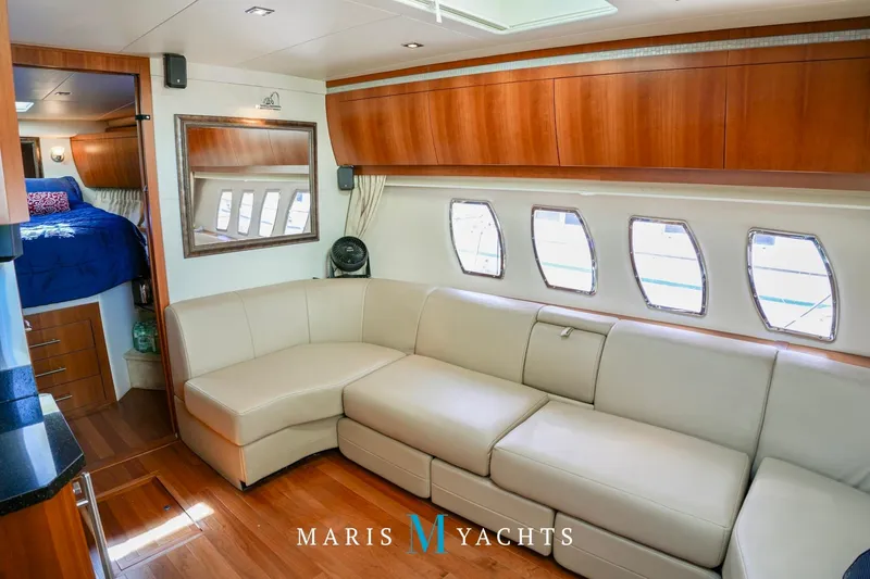  Yacht Photos Pics Luxurious interior of 2009 Regal 52 Sport Coupe yacht with leather seating and wood accents.