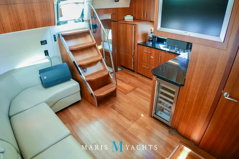  Yacht Photos Pics Luxurious interior of 2009 Regal 52 Sport Coupe yacht with modern amenities and wooden finishes.