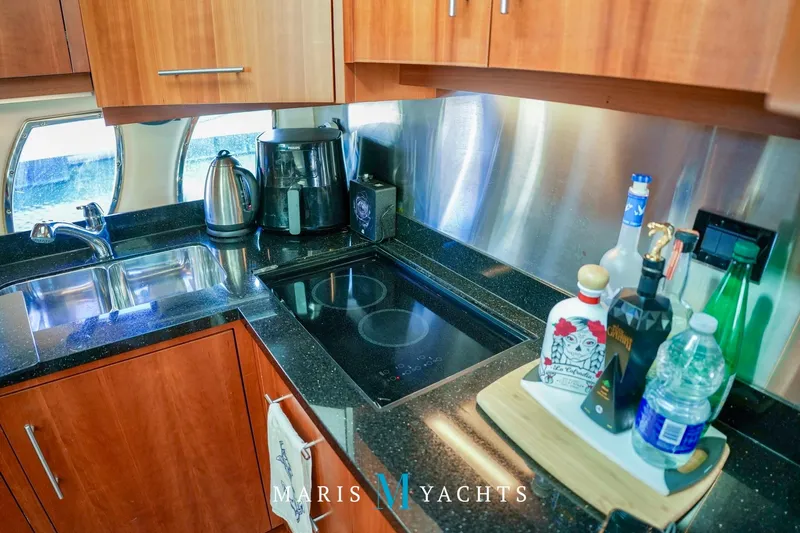  Yacht Photos Pics Luxurious 2009 Regal 52 Sport Coupe yacht kitchen with modern appliances and sleek design.