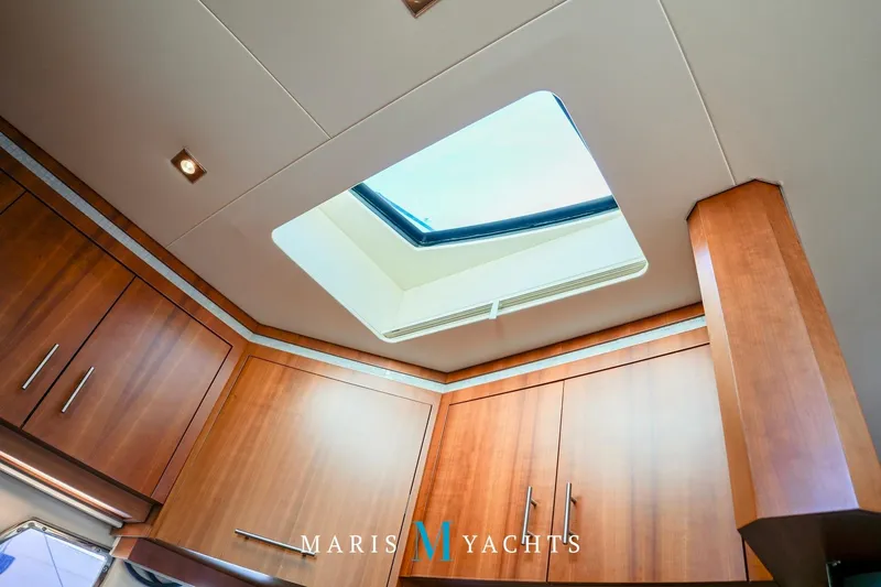  Yacht Photos Pics Interior view of 2009 Regal 52 Sport Coupe yacht with wooden cabinets and skylight.