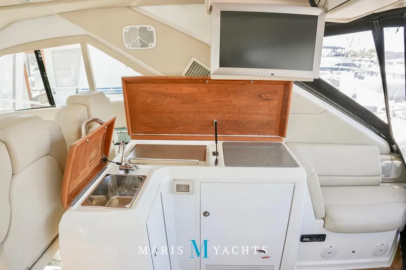  Yacht Photos Pics Interior of 2009 Regal 52 Sport Coupe yacht with kitchenette and TV.