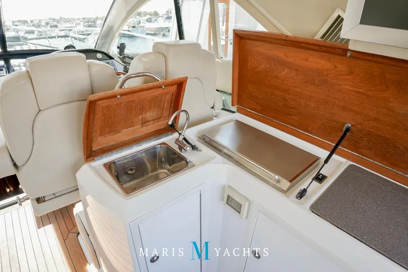 Yacht Photos Pics 2009 Regal 52 Sport Coupe yacht interior with sink and seating area.