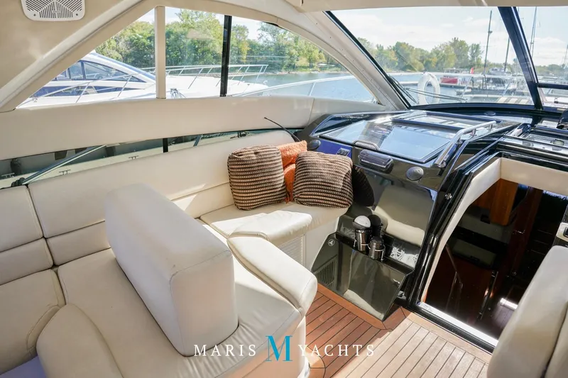  Yacht Photos Pics Luxurious interior of 2009 Regal 52 Sport Coupe yacht with plush seating and modern helm.