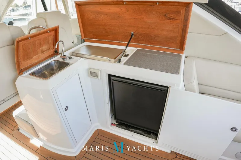  Yacht Photos Pics 2009 Regal 52 Sport Coupe yacht interior with kitchenette, sink, and mini-fridge.