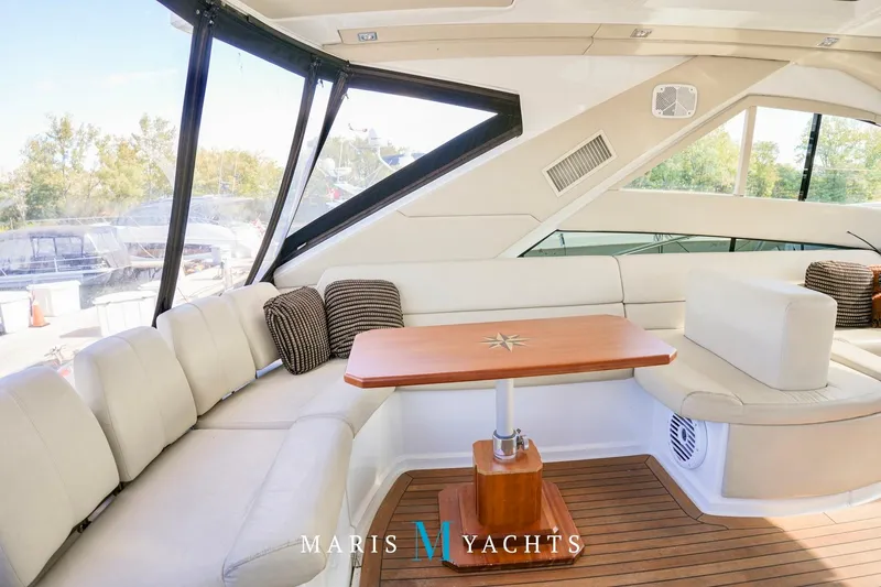  Yacht Photos Pics Luxurious interior of 2009 Regal 52 Sport Coupe yacht with elegant seating and wooden table.