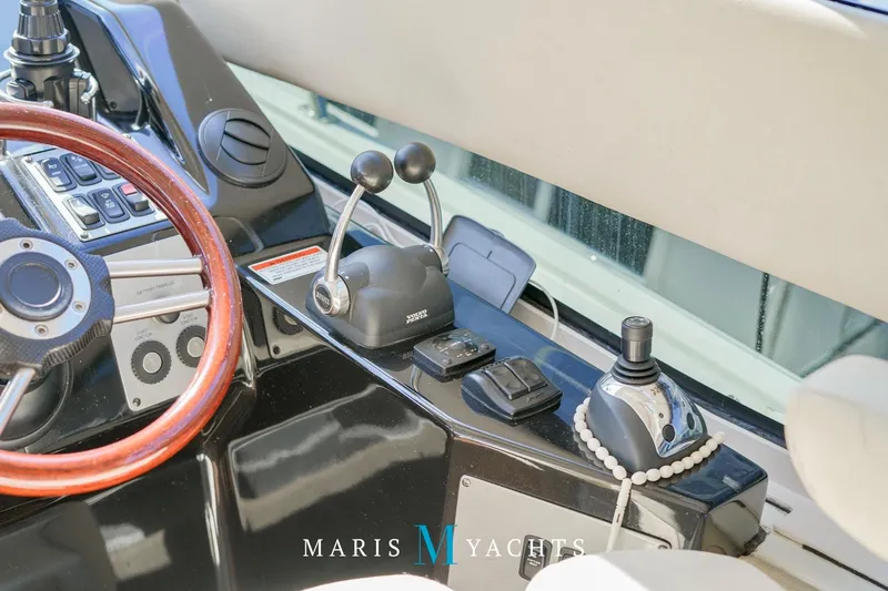  Yacht Photos Pics 2009 Regal 52 Sport Coupe helm with controls and wooden steering wheel.