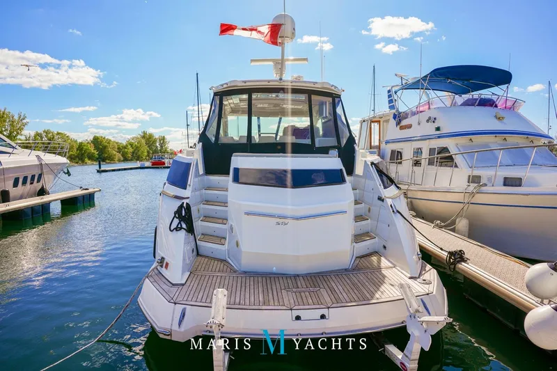  Yacht Photos Pics 2009 Regal 52 Sport Coupe yacht docked at marina under clear blue sky.