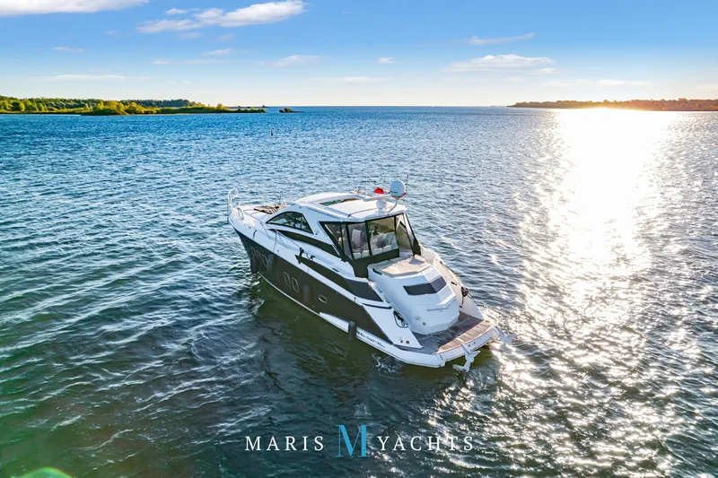  Yacht Photos Pics 2009 Regal 52 Sport Coupe yacht cruising on a sunny, tranquil sea.