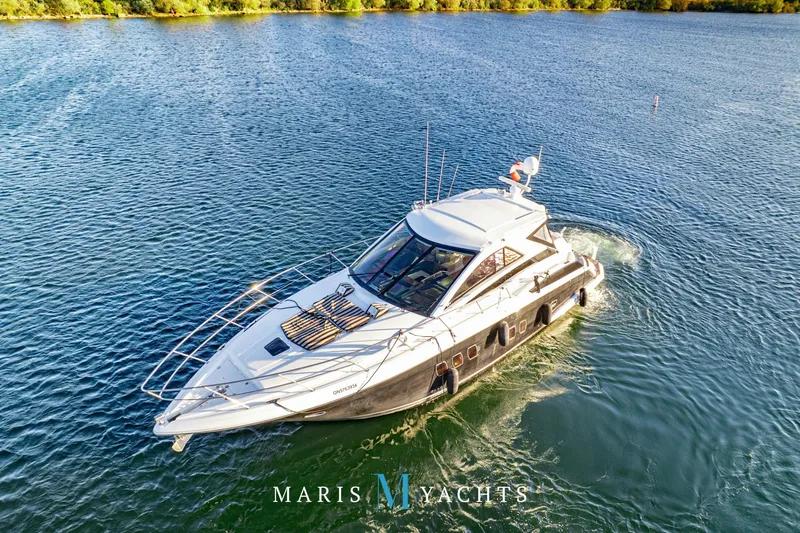  Yacht Photos Pics 2009 Regal 52 Sport Coupe yacht cruising on a serene lake.