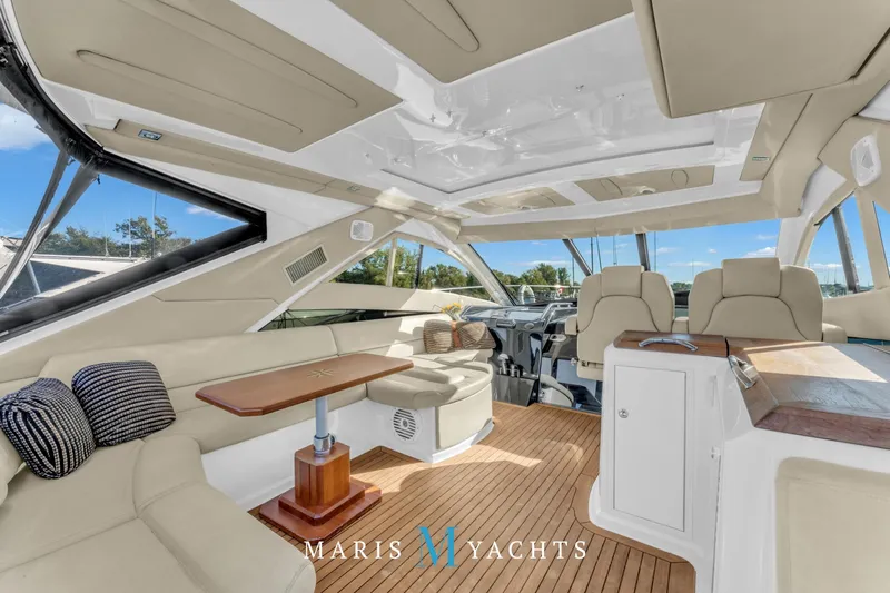  Yacht Photos Pics Luxurious interior of 2009 Regal 52 Sport Coupe yacht with elegant seating and wooden accents.