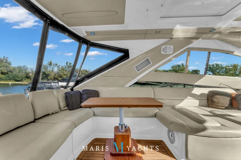  Yacht Photos Pics Luxurious interior of 2009 Regal 52 Sport Coupe yacht with elegant seating and table.