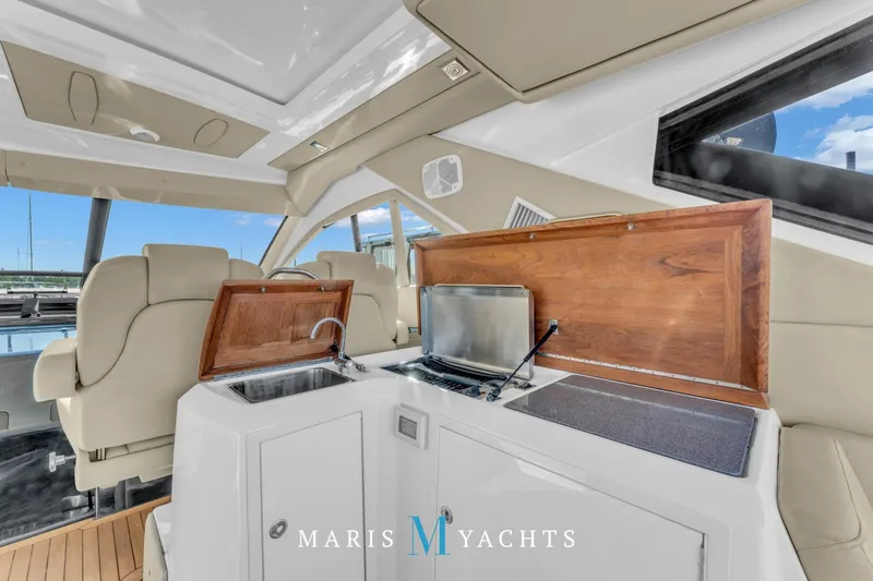  Yacht Photos Pics Luxurious interior of 2009 Regal 52 Sport Coupe yacht with kitchenette and seating area.