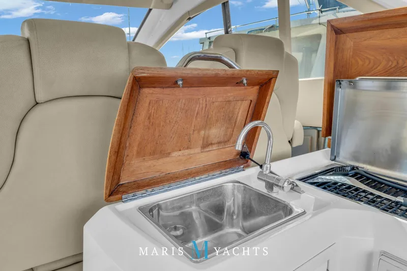  Yacht Photos Pics Luxurious 2009 Regal 52 Sport Coupe yacht interior with sink and wooden accents.