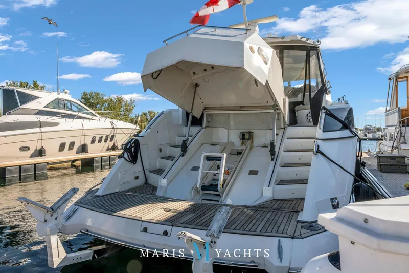  Yacht Photos Pics 2009 Regal 52 Sport Coupe yacht docked, showcasing spacious rear deck and elegant design.
