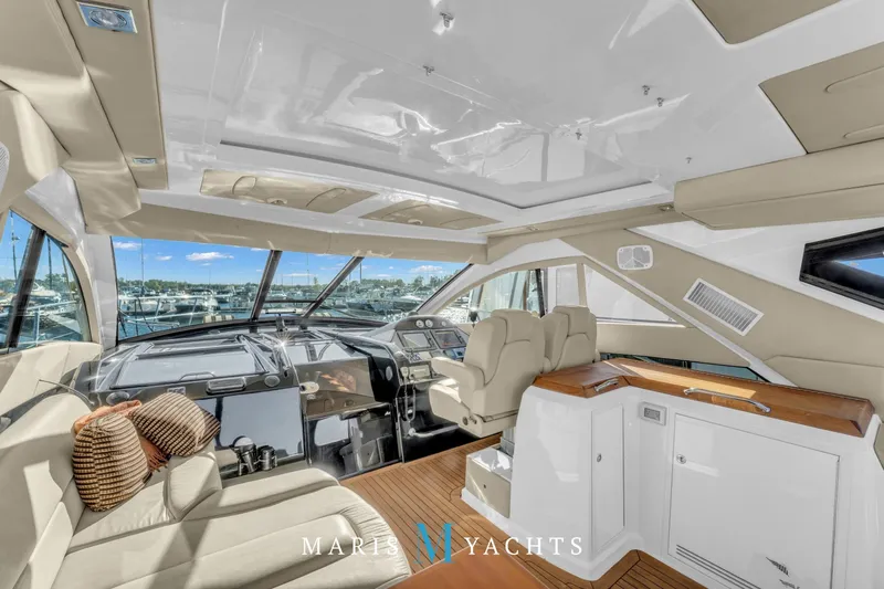  Yacht Photos Pics Luxurious interior of a 2009 Regal 52 Sport Coupe yacht with plush seating and modern helm.