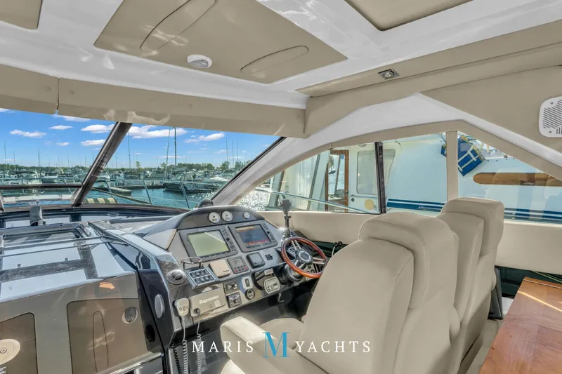  Yacht Photos Pics Interior view of 2009 Regal 52 Sport Coupe yacht cockpit with marina background.