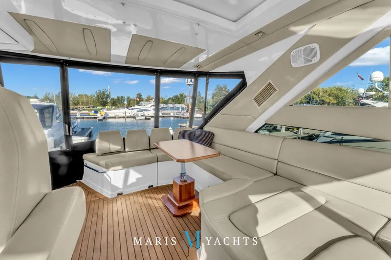  Yacht Photos Pics Luxurious interior of 2009 Regal 52 Sport Coupe yacht with spacious seating and scenic marina view.