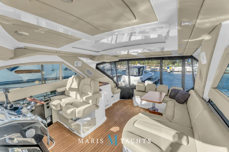  Yacht Photos Pics Luxurious interior of 2009 Regal 52 Sport Coupe yacht with plush seating and scenic marina view.